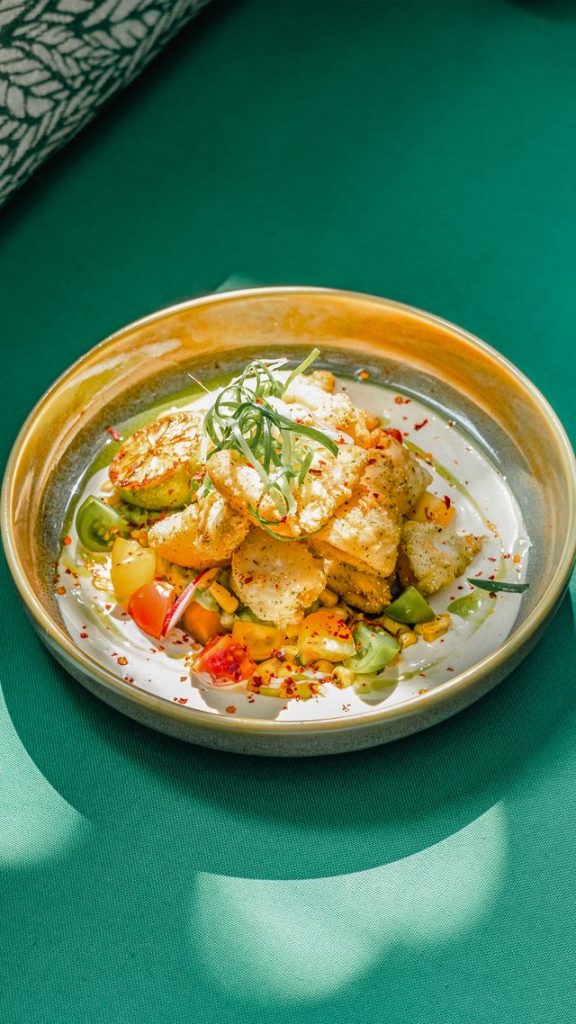 Delicious fish fillet served with vegetables and herbs on a stylish plate, highlighting fine dining at Menlyn.