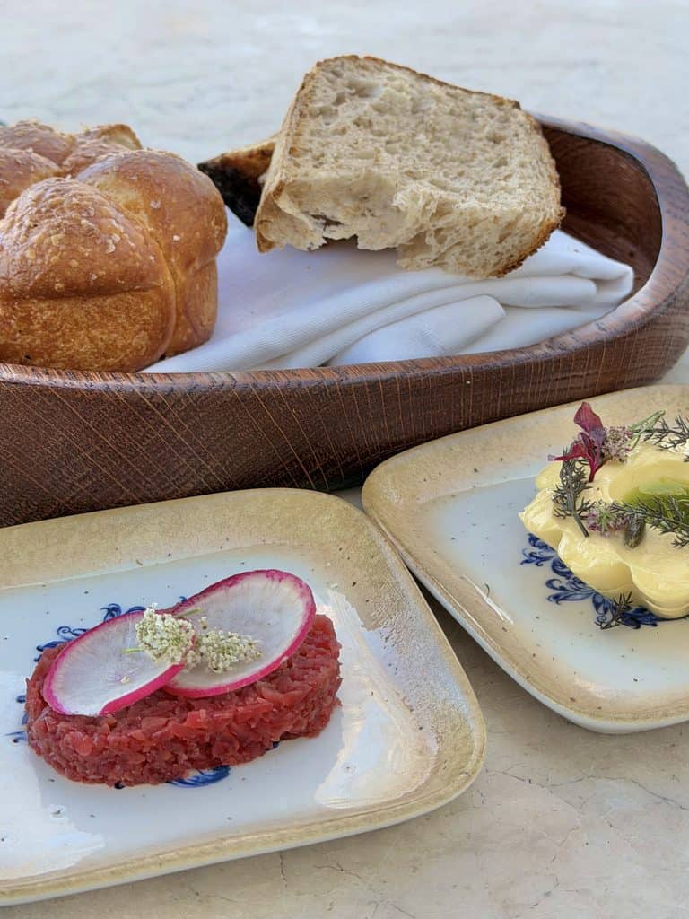 Fresh bread, butter, and gourmet spreads served on ceramic plates at Hazendal Wine Estate in Stellenbosch.