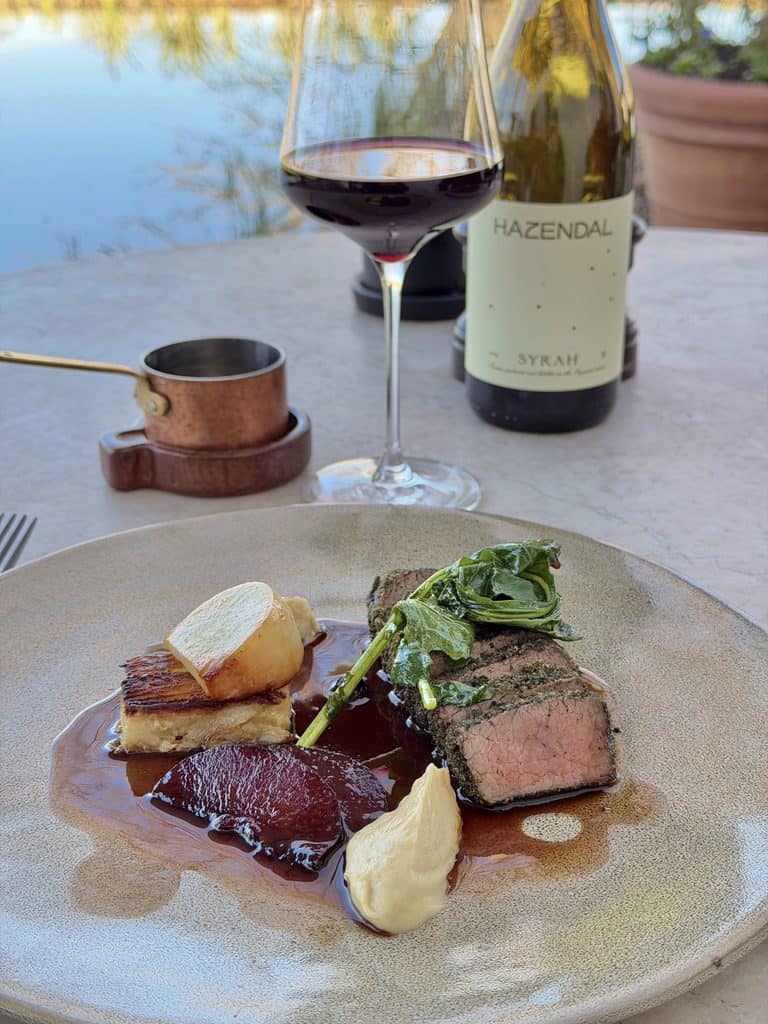 Gourmet steak with vegetables and sauces at Hazendal Wine Estate, Stellenbosch.
