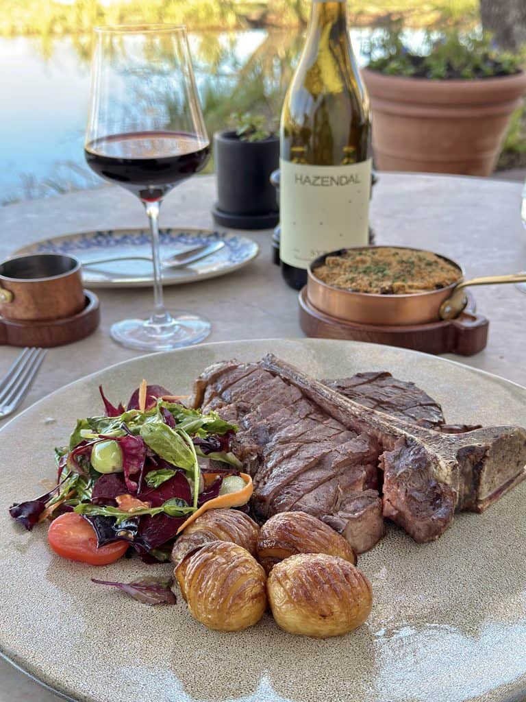 Delicious grilled steak with roasted potatoes and fresh salad at Hazendal Wine Estate, Stellenbosch.