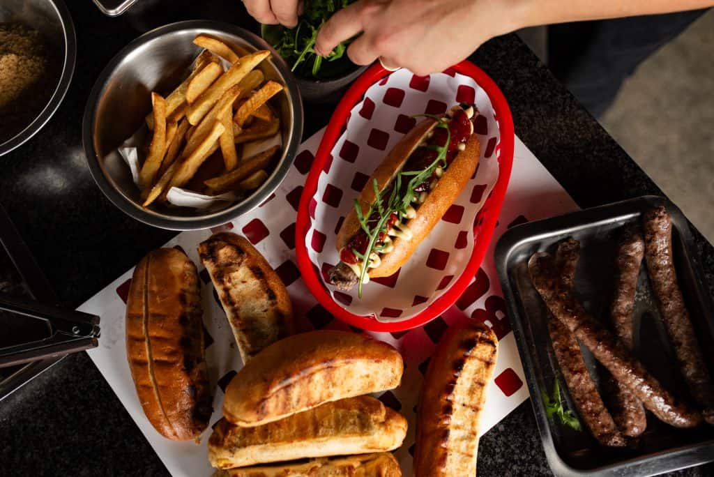 South African-style hot dog with fries and grilled sausages at Buri's Lekker Celebration event.